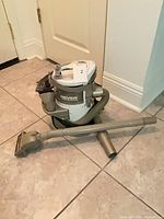 Shark NP319 canister vacuum with hose, wand and brush displayed on floor