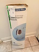 Front of boxed The Container Store adjustable chrome garment rack