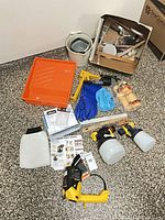 Full kit layout including sprayer, cups, tray, rollers, brushes, gloves, manuals