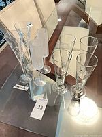 Full set of eight champagne flutes on glass table