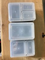 Stacks of lidded containers showing lid transparency and compartment shapes