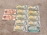 Full lot layout showing 2 $2 and 10 $1 banknotes