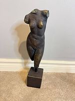 Front view of bronze-finish female torso sculpture on square base