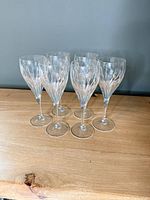 Front view of six crystal wine goblets standing together