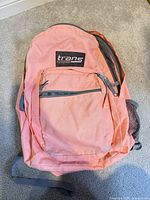 Front view showing logo, front pocket, coral fabric