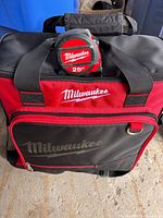 Milwaukee tool bag with 25-ft tape measure resting on top
