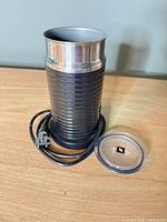 Full view of frother, lid, and corded base