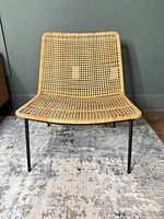 Front view of rattan chair showing seat, backrest and legs