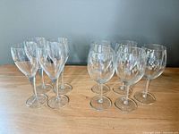 Group shot of all nine wine glasses on wooden surface