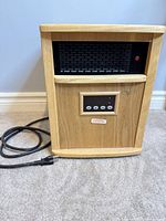 front view of wood cabinet heater showing vent, control panel, power cord