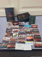 Fronts of sample cards, sealed box, binder and checklist visible