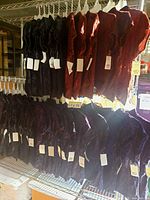 Rows of velvet tops hanging, showing color assortment and tags attached