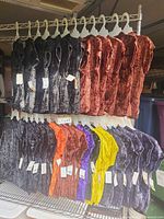 Front view of all tops on rack showing color assortment and tags