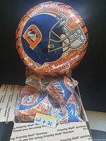 Inflated Denver Broncos foil balloon with helmet graphic and text