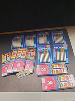 All packs of gel pens and watercolor sets laid out
