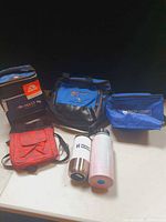 Group view of four cooler bags and two drink containers