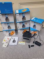 Stack of eight Philips AJT3300 boxed units with one unit, power adapter and manuals displayed