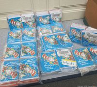 Multiple stacks of sealed Cat in the Hat invitation card packs