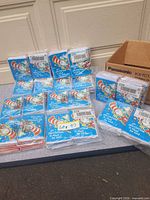 Multiple sealed packs of Cat in the Hat invitations spread out to show quantity