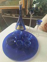 Entire lot showing tray, bottle, candle holders, cups, bowl