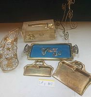 Group shot showing all six brass and gold-tone items