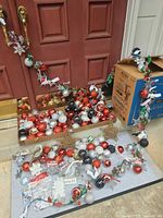 Overall lot showing ball ornaments in trays, string lights draped, boxes and additional pieces