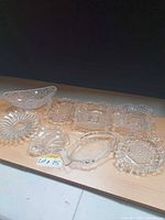 All eight clear glass pieces arranged on table