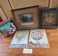 All five framed art pieces standing on floor for group overview