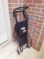 Cart folded upright against wall, front view