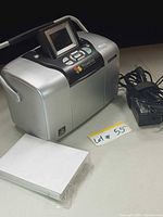 Printer, power adapter, photo paper shown together