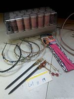 Group shot showing Clairol hairsetter, headbands, hair sticks, fabric headbands