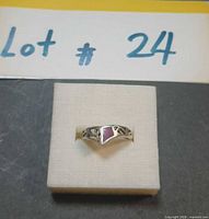 Front view of sterling silver ring with pink stone displayed on foam box