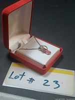 Necklace in red velvet box with lot tag visible