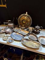 All silver-plated items grouped on table