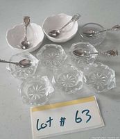 All nine salt cellars and five spoons displayed