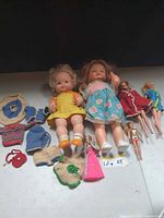 Group shot of all dolls and crochet clothes on surface