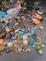 Pile of mixed jewelry pieces close-up showing variety