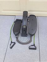 Top view of compact strider showing both foot pedals and resistance cords