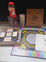 Overall view showing gumball machine on box, Tampa Bay puzzle tube, Word Quest board, cards and box
