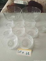 Overview of two large and nine small clear glass bowls on table