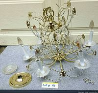 Chandelier frame, bobeches, canopy and crystals laid out