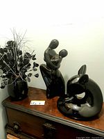 Group shot of lovers sculpture, deer and vase on table