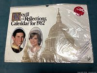 Front of sealed 1982 Royal Reflections calendar showing portraits of Prince Charles and Princess Diana with St Paul’s Cathedral image