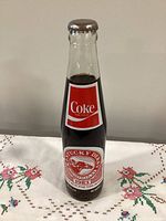 Front view of unopened 10oz Coca-Cola Kentucky Derby 1983 commemorative bottle