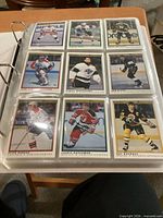 Album page showing nine 1990-91 OPC Premier cards in sleeves