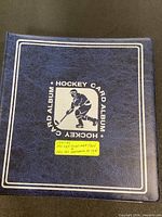 Front cover of blue Hockey Card Album binder with handwritten label