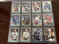 All twelve 1993-94 Topps Premier Finest hockey cards in hard sleeves, arranged in three rows of four