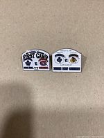 Front view of both 1999 Toronto Maple Leafs commemorative pins showing design details and event information