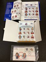 Folder opened showing souvenir sheet of 15 circular stamps and sealed first day cover