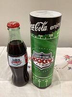 Bottle and tube standing side by side showing labels and graphics